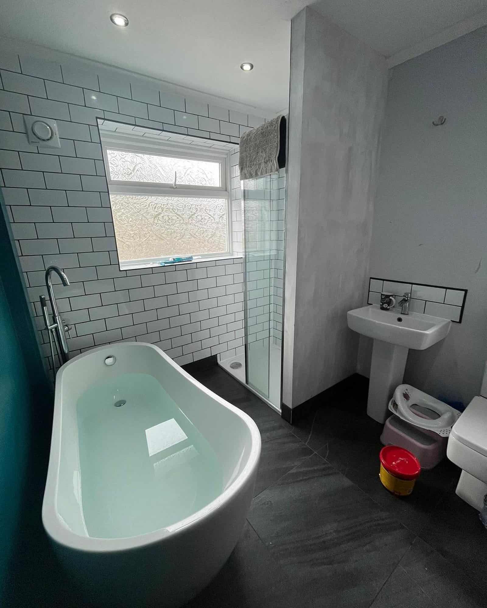 Modern bathroom with bath, shower, and sink.